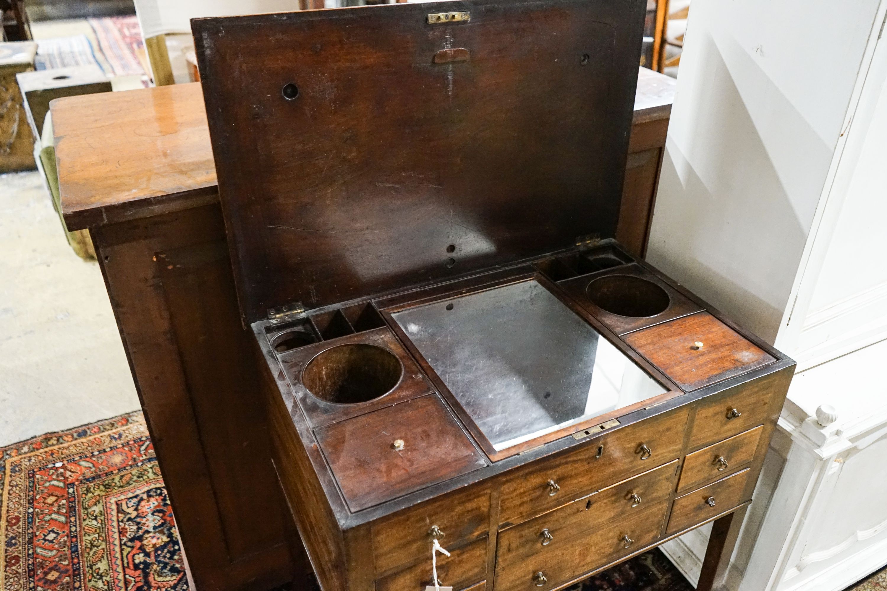 A George III mahogany enclosed washstand with hinged top, width 78cm, depth 49cm, height 84cm